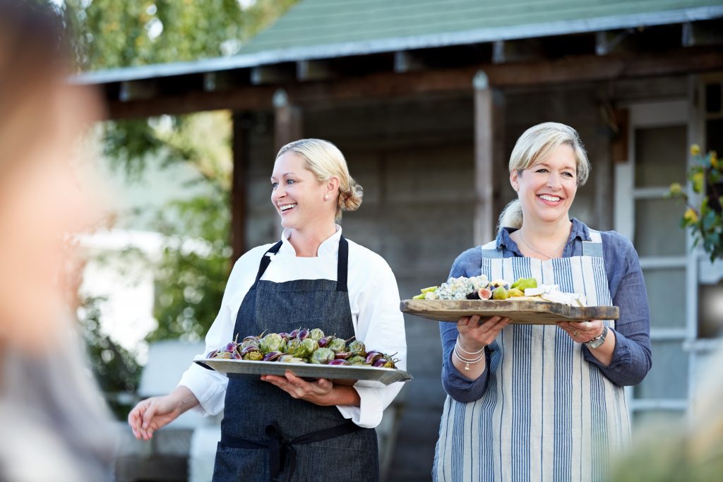 Caterers from Catering Services in Washington DC serving gourmet meals at an outdoor event.